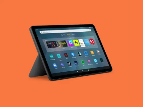 A sleek tablet on a black stand displaying various app icons on a gray background, set against an orange backdrop.
